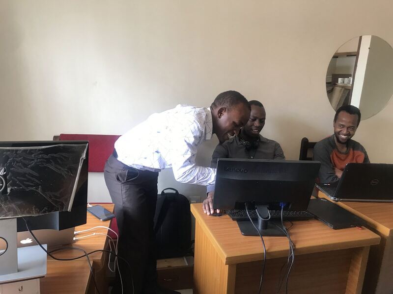 Leaning over a colleague’s desk, walking them through software on screen